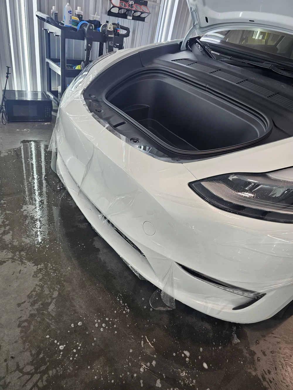 Tesla front end mid-install with STEK paint protection film at Tri City Auto Labz