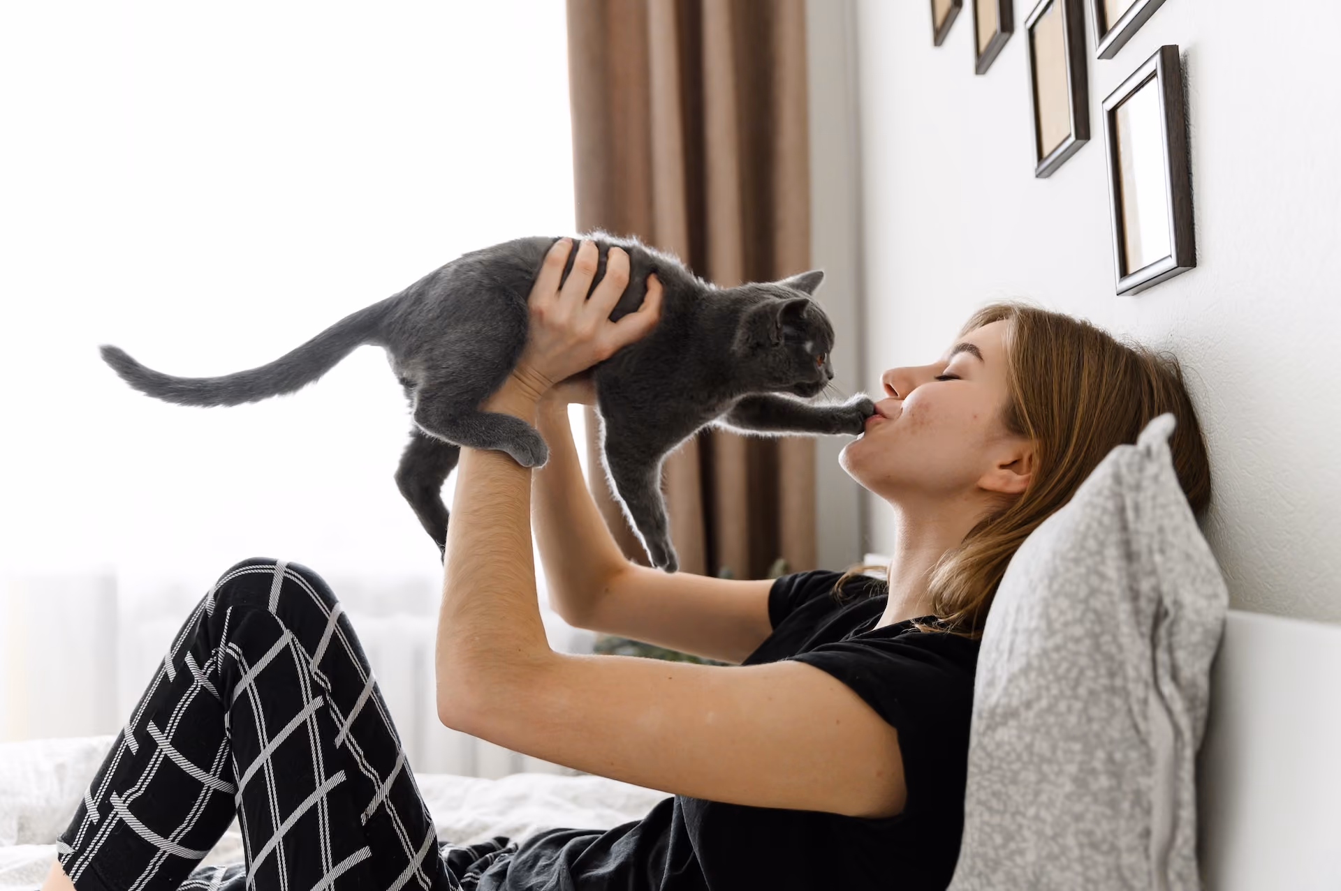 Girl kissing cat