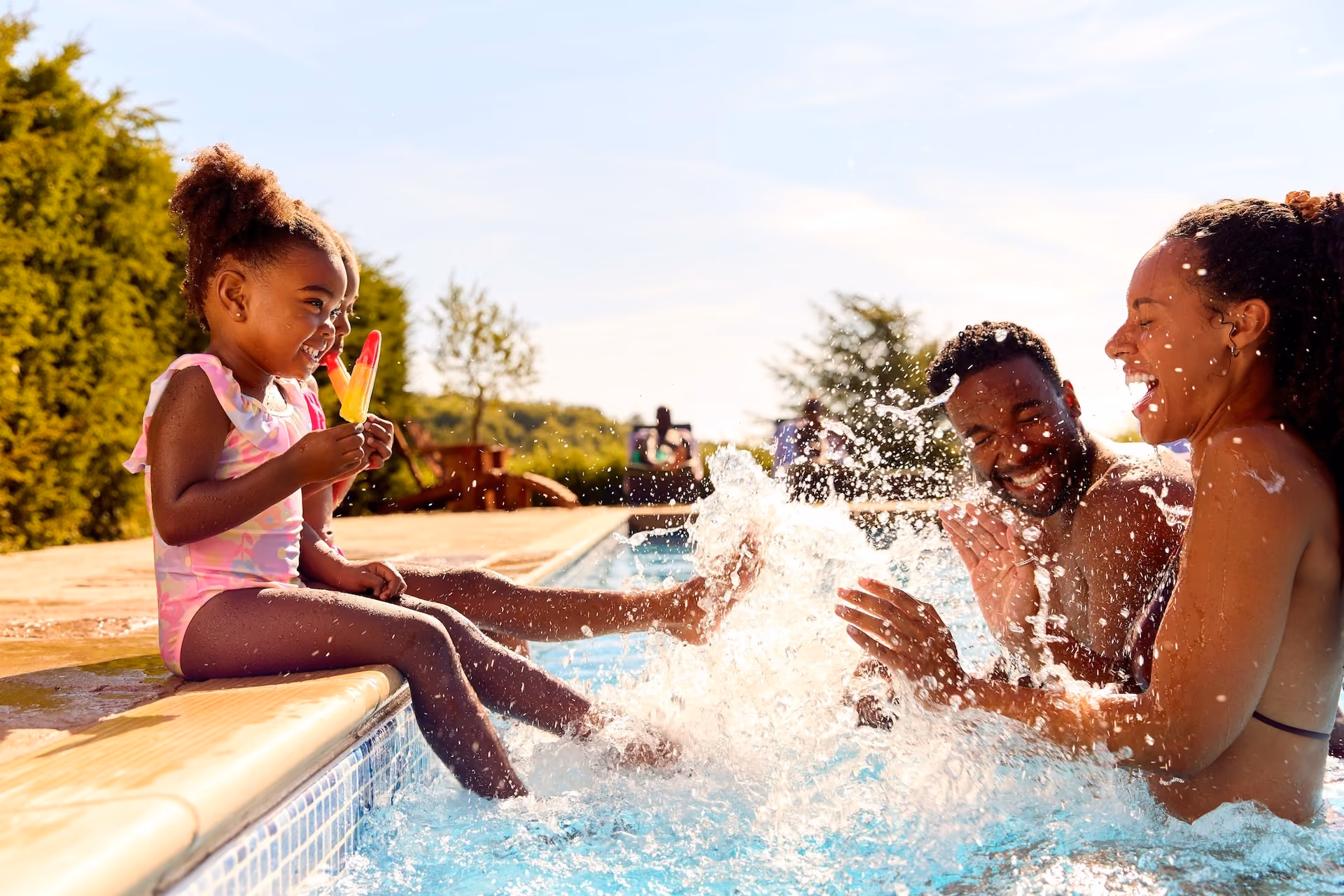 Family playing in pool