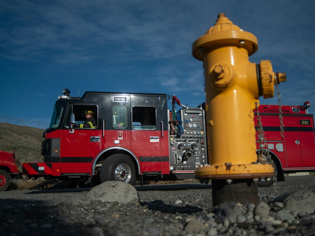 Fire engine and yellow hydrant outside the station