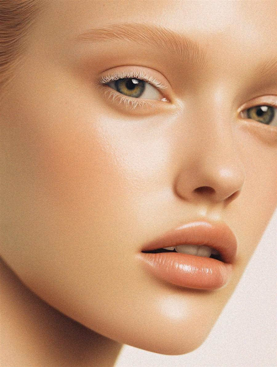 Close-up of a woman's glowing, freckled skin