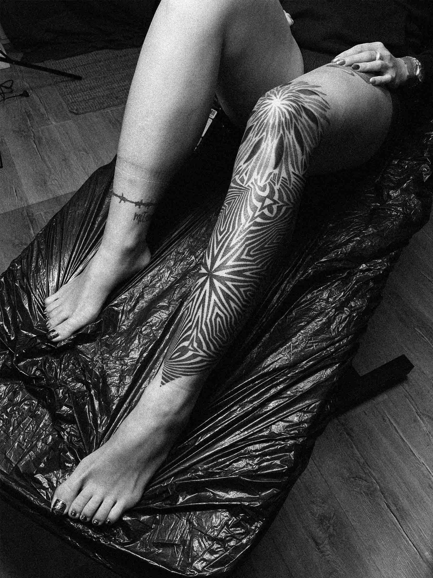 Tatuaż damski na nodze i kolanie, dotwork, blackwork geometryczny - autorska praca Pawła Kurylaka | Zdjęcie wykonane w studio tatuażu w Gdańsku