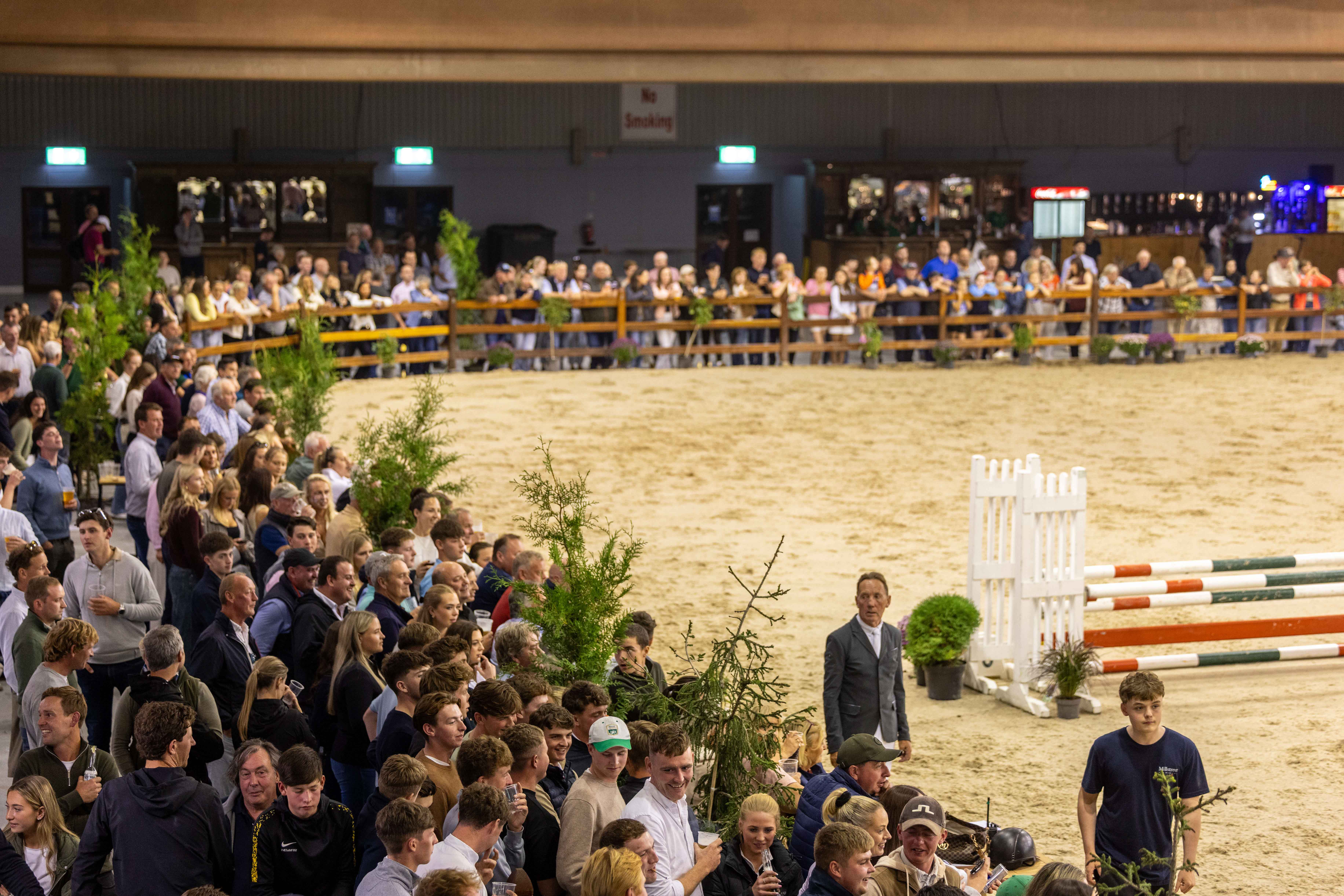 Crowd watching show jumping at an equestrian event