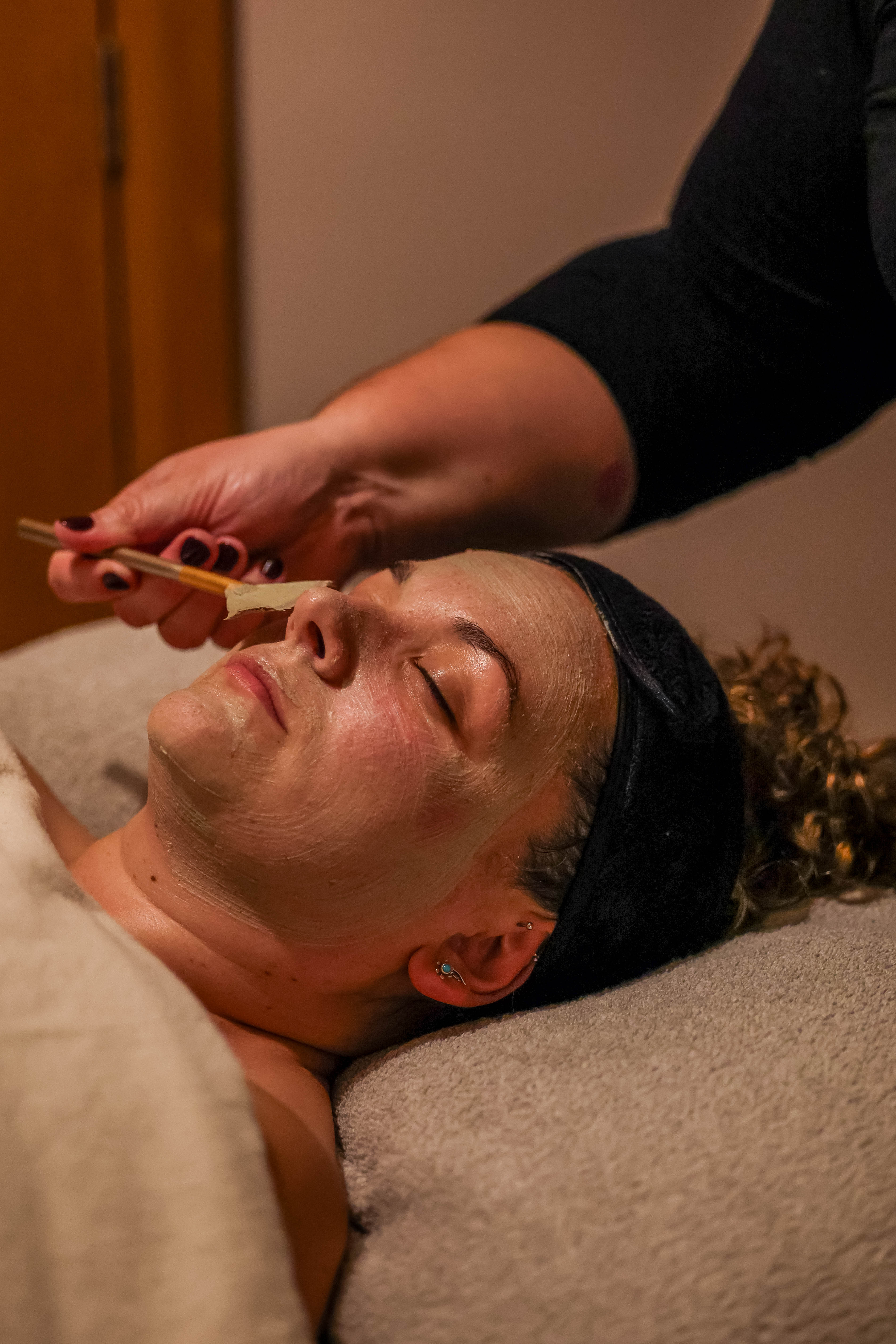 Woman receiving a relaxing facial treatment