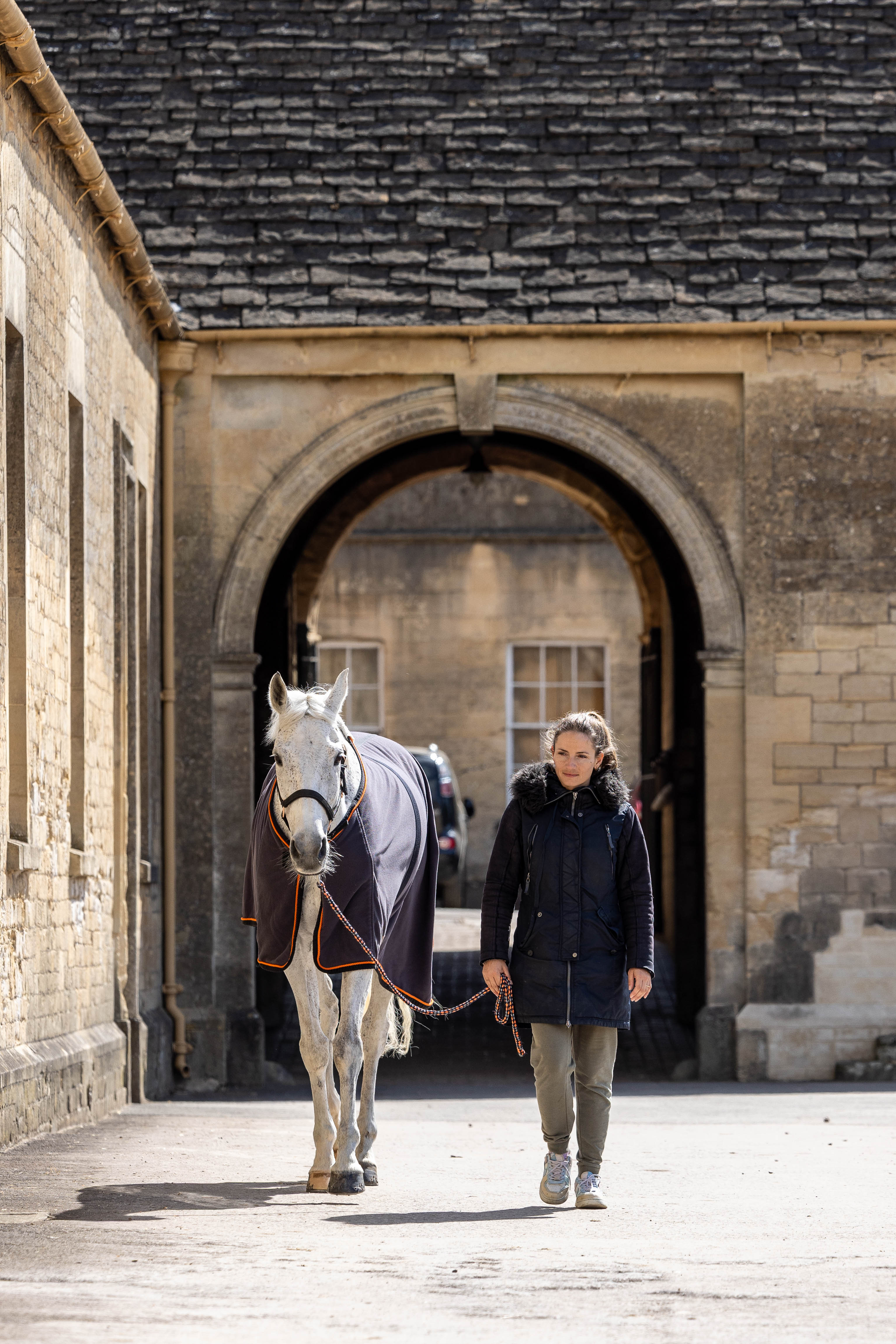 Equestrian event attendees outside a historic venue