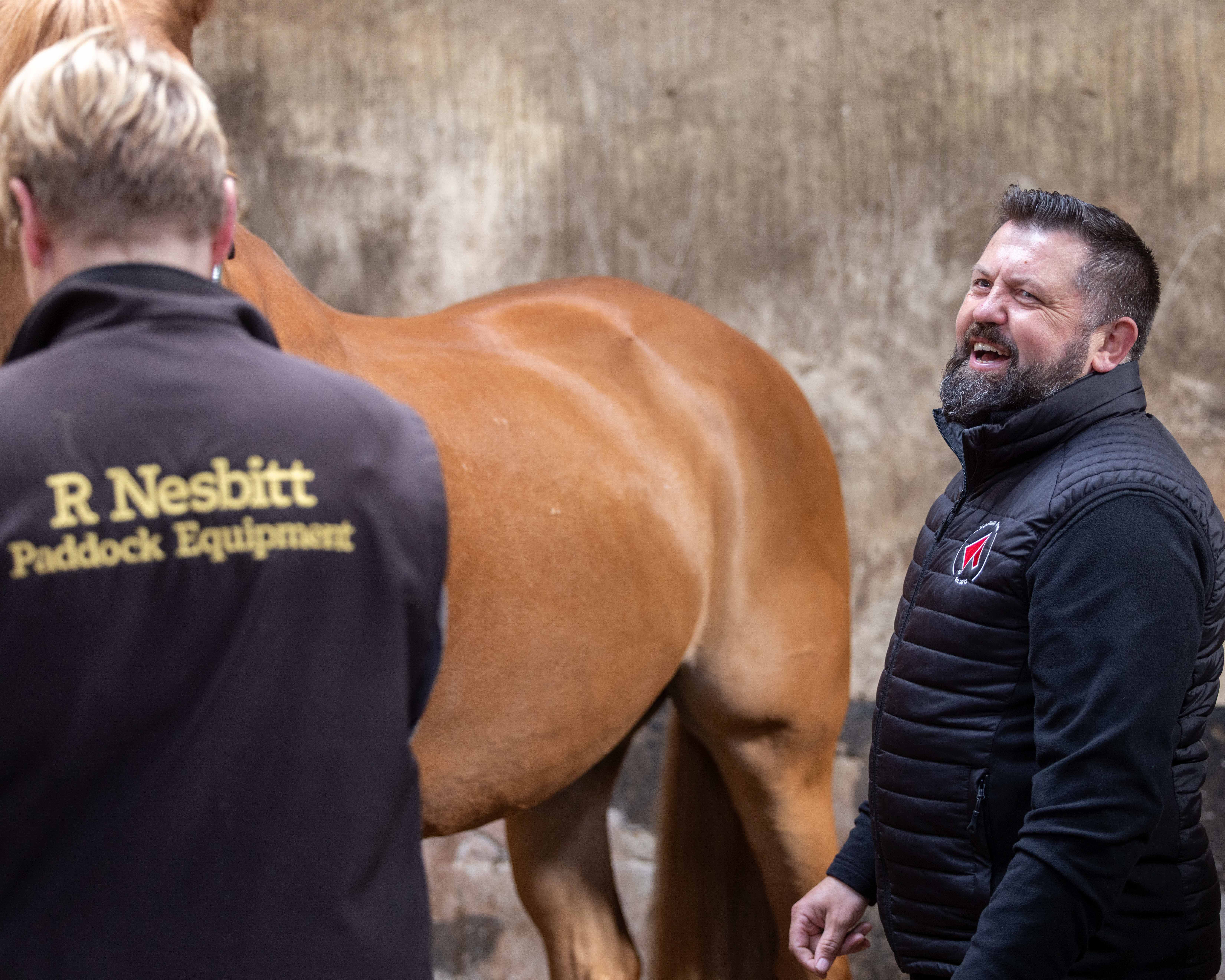 Equestrian feed adviser working with a horse