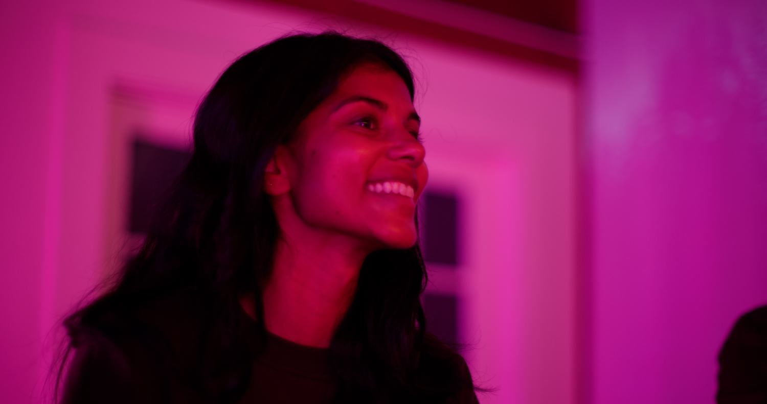A guest smiling in warm daylight after a session.