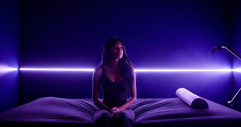 A guest on the WaveTable before a session, lit by a single bar of violet light.