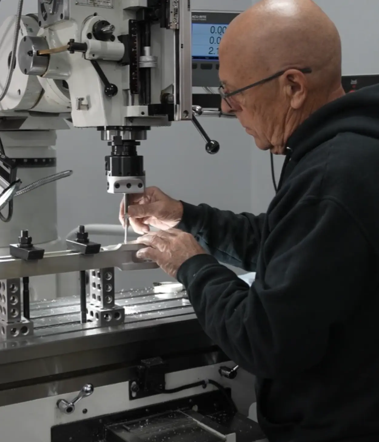 AAI machinist working on an aircraft part at a milling machine