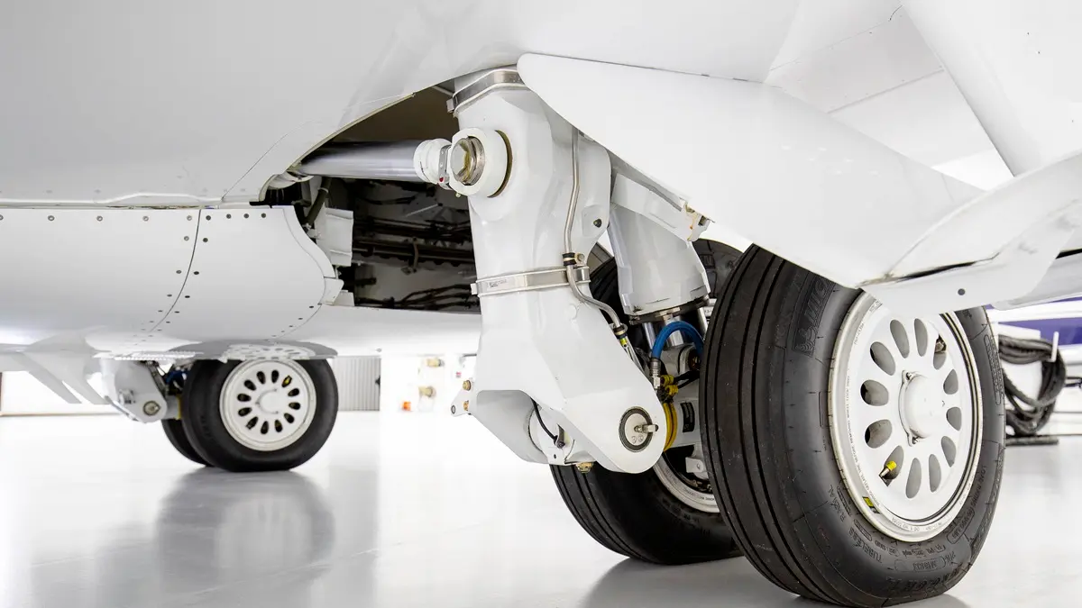 Cessna Citation main landing gear with wheels and brake assembly in a hangar