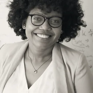 Mireille Osei, partner for energy and utilities, in front of a whiteboard covered in notes