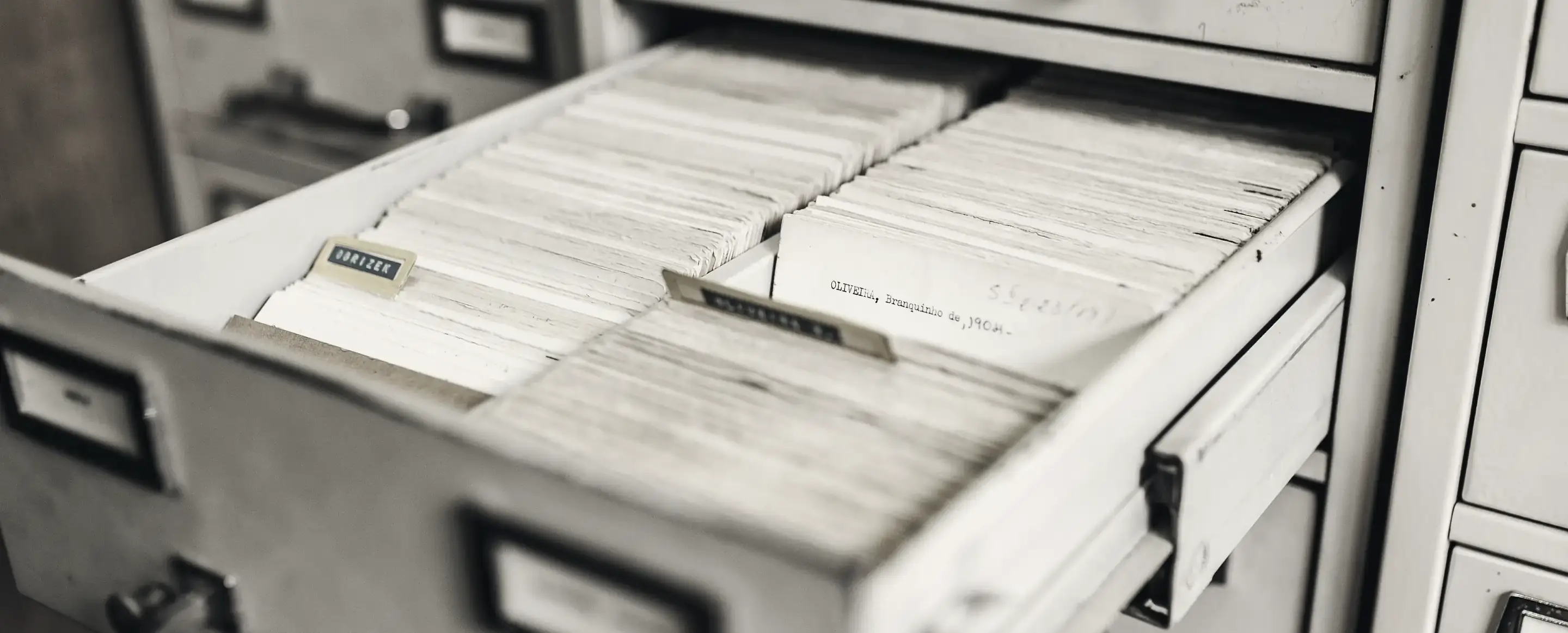 A card index drawer pulled open in a metal filing cabinet
