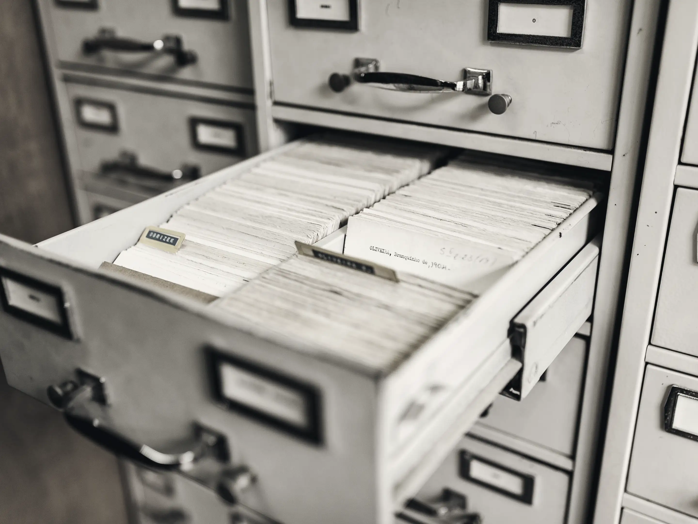 A card index drawer pulled open in a metal filing cabinet