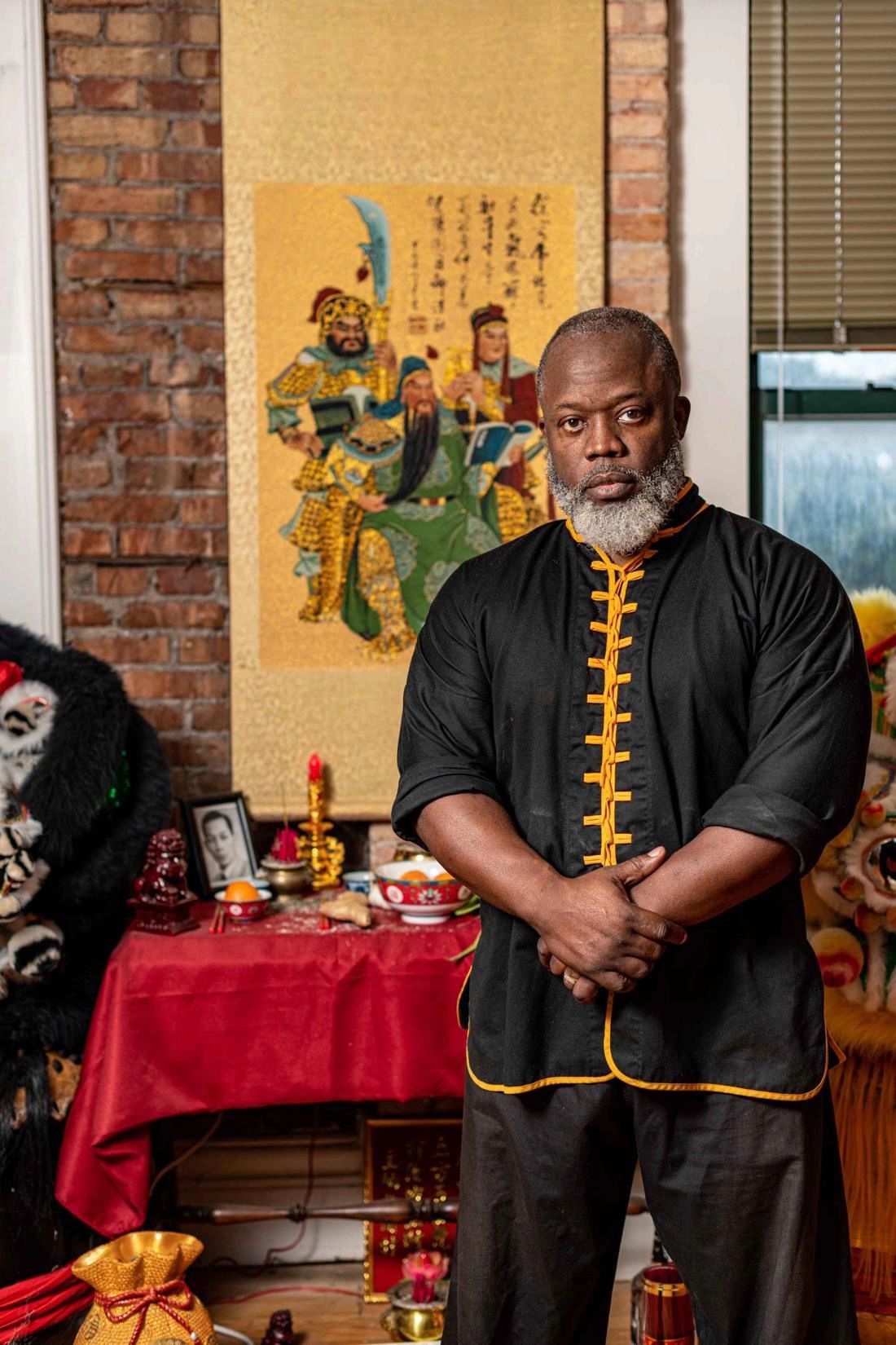 Sifu Bey standing calmly before the school altar