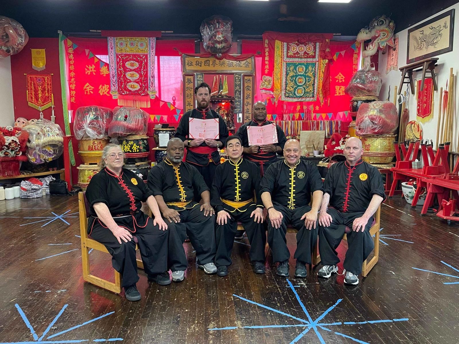 Sifu Sharif Anael-Bey seated with Grandmaster Frank Yee Chee Wai and senior Yee's Hung Ga instructors