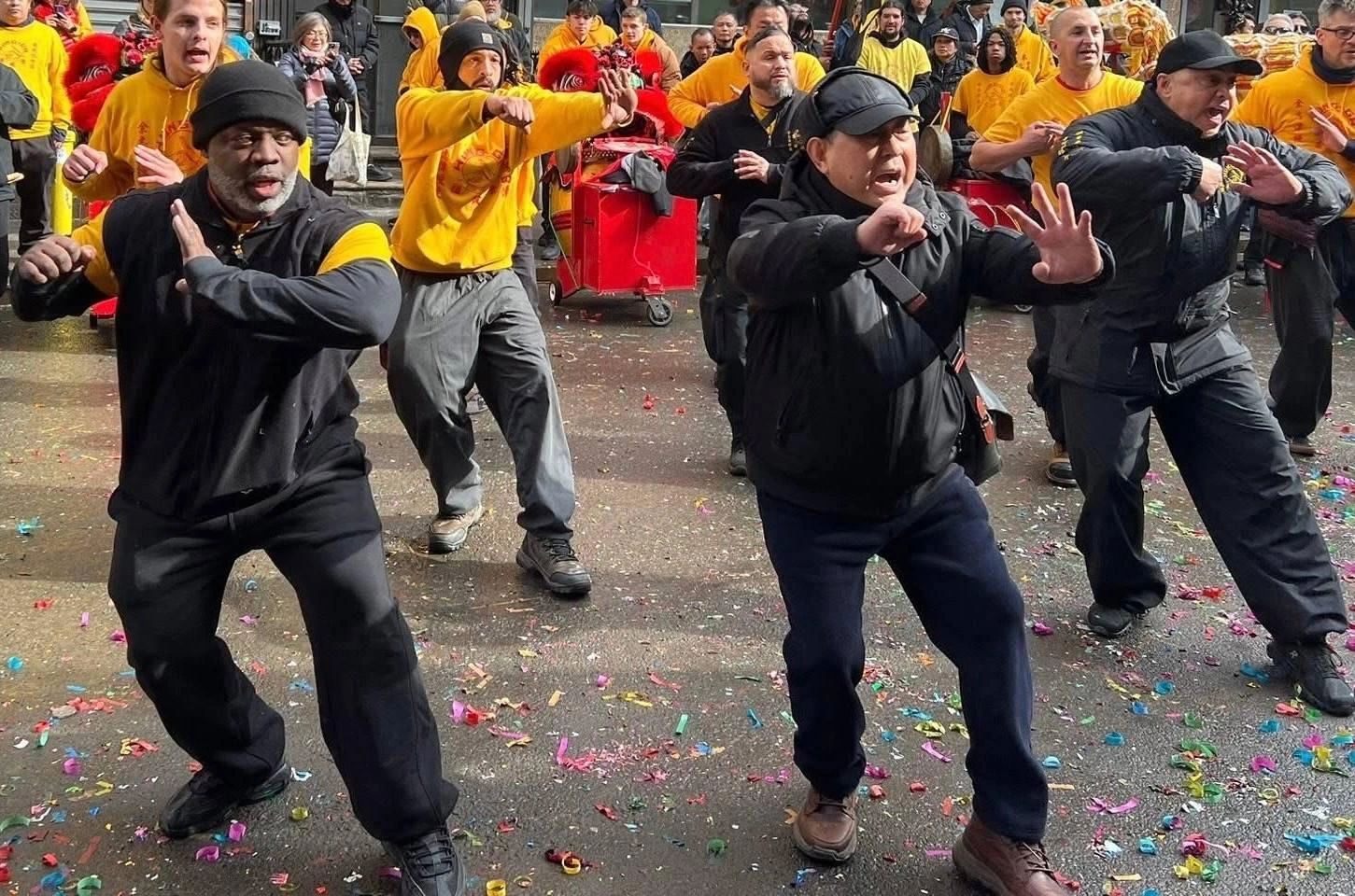 Sifu Bey performing Hung Ga in the street at a Lunar New Year celebration with lion dancers behind him