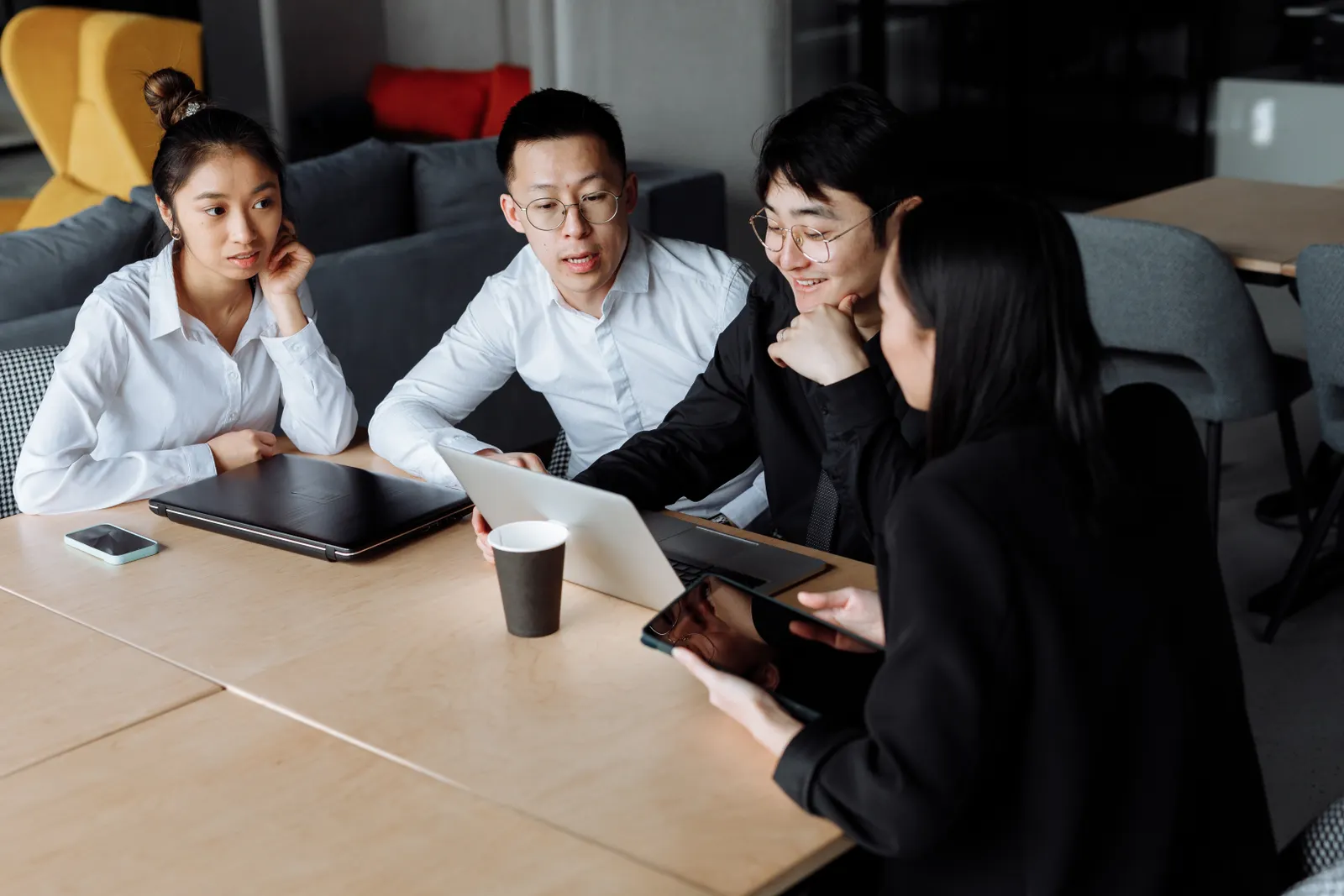 Colleagues reviewing a business plan together around a laptop