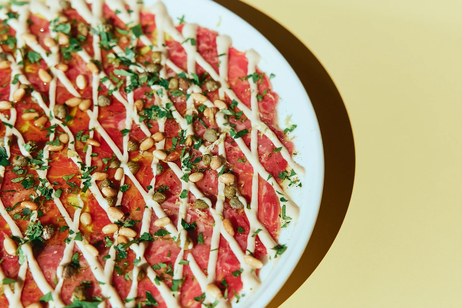 Carpaccio with herbs, pine nuts and aioli at The Tropic