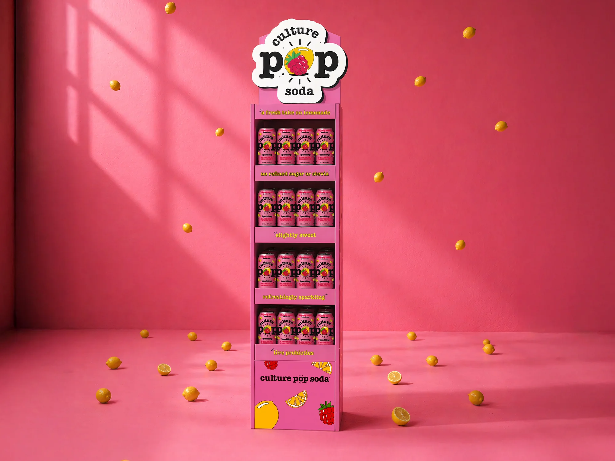 Retail floor shipper display for Culture Pop Raspberry Lemonade probiotic soda, tall pink five-shelf unit with branded header, stacked cans, and benefit callouts including a fresh take on lemonade, no refined sugar or stevia, slightly sweet, refreshingly sparkling, and live probiotics