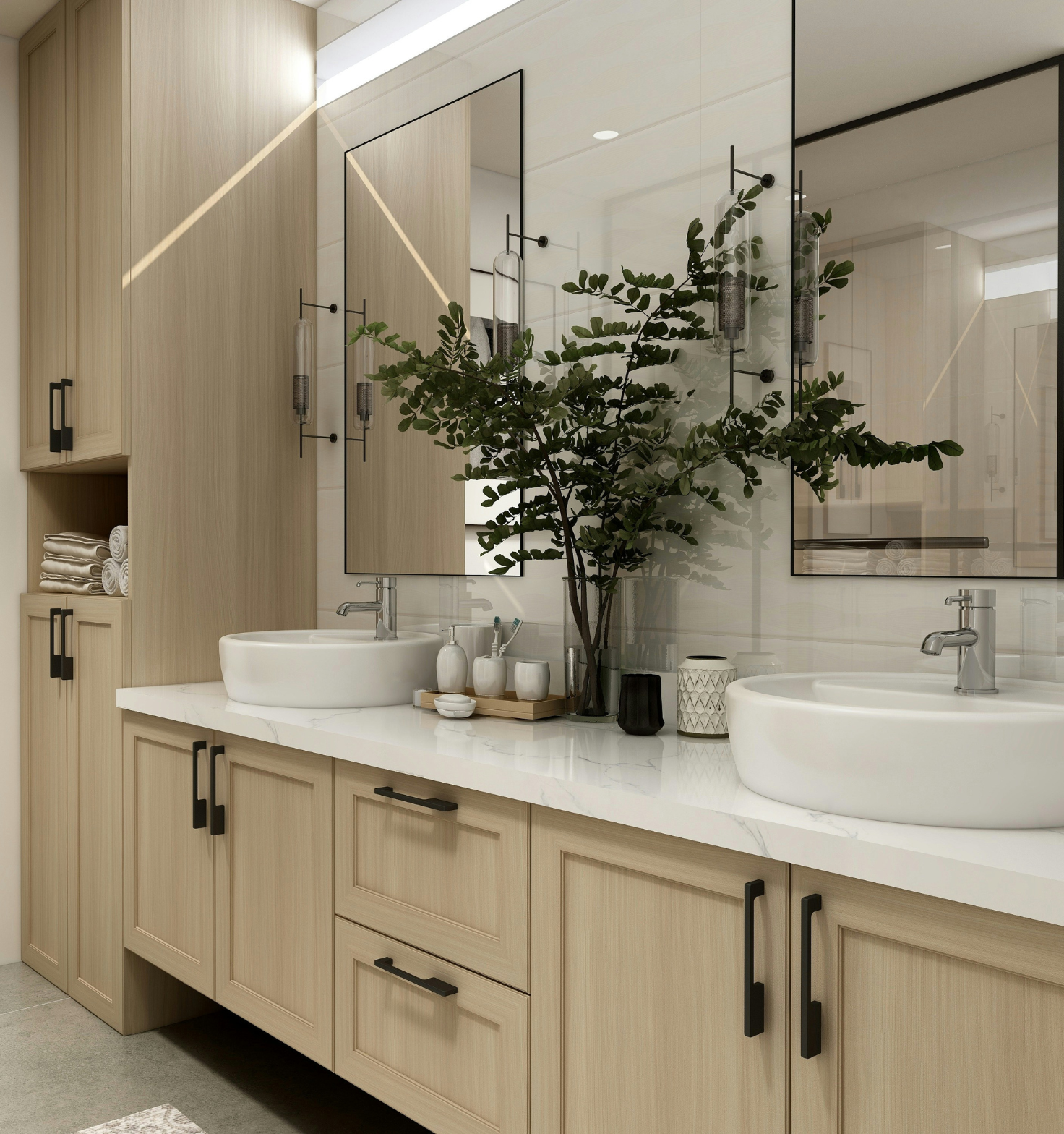 Modern bathroom vanity with light wood cabinets, white marble countertop, two round white vessel sinks, and black framed rectangular mirrors; a large green leafy plant in a glass vase sits between the sinks with soap dispenser and toothbrush holders on a wooden tray on the countertop.
