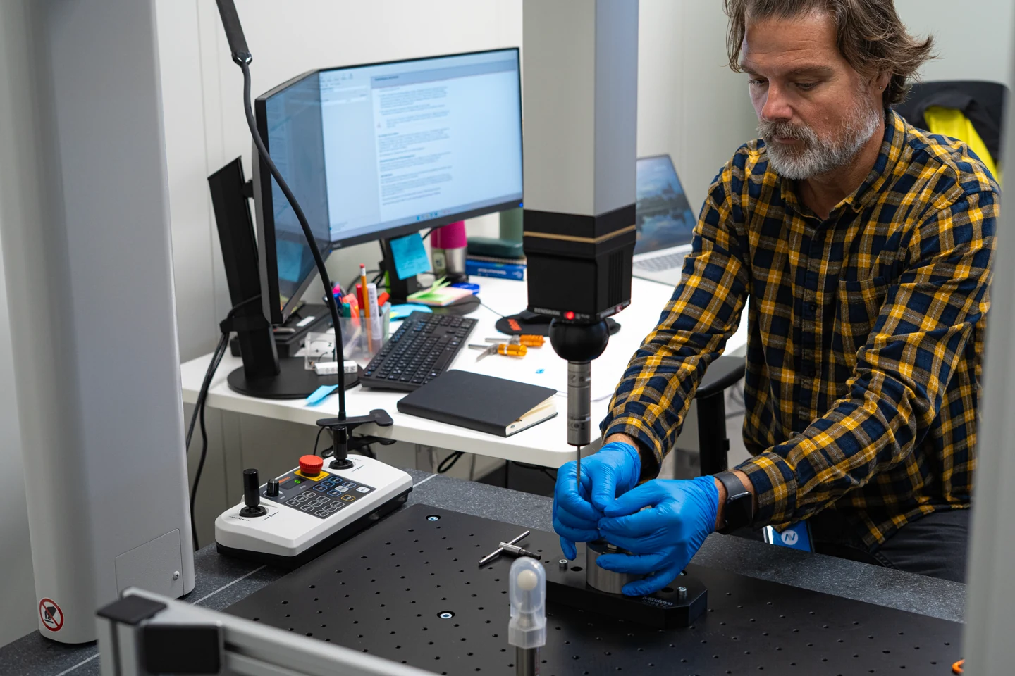 Precision inspection of a deltaVision component using measuring equipment.