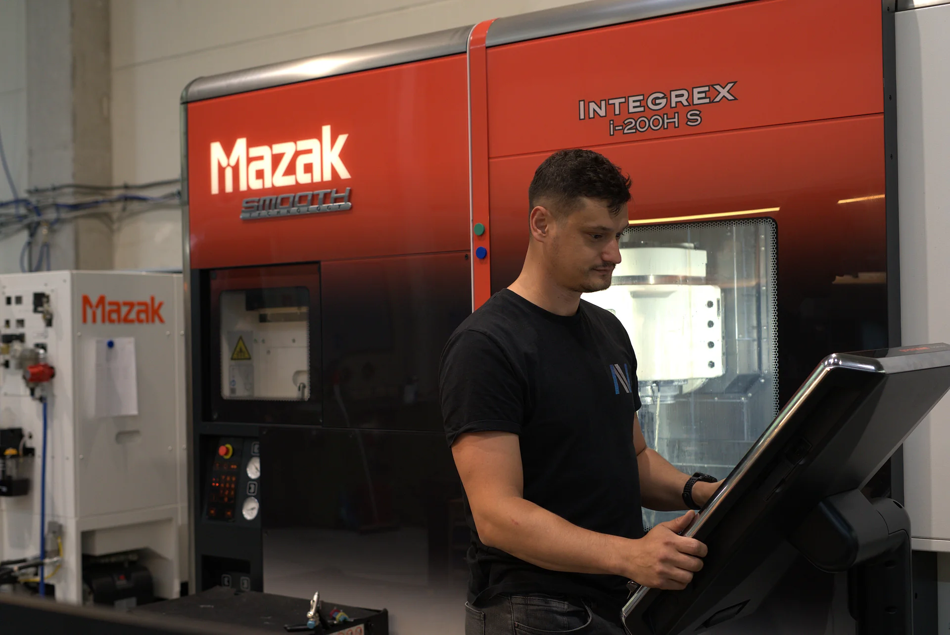 Technician operating a CNC machining centre