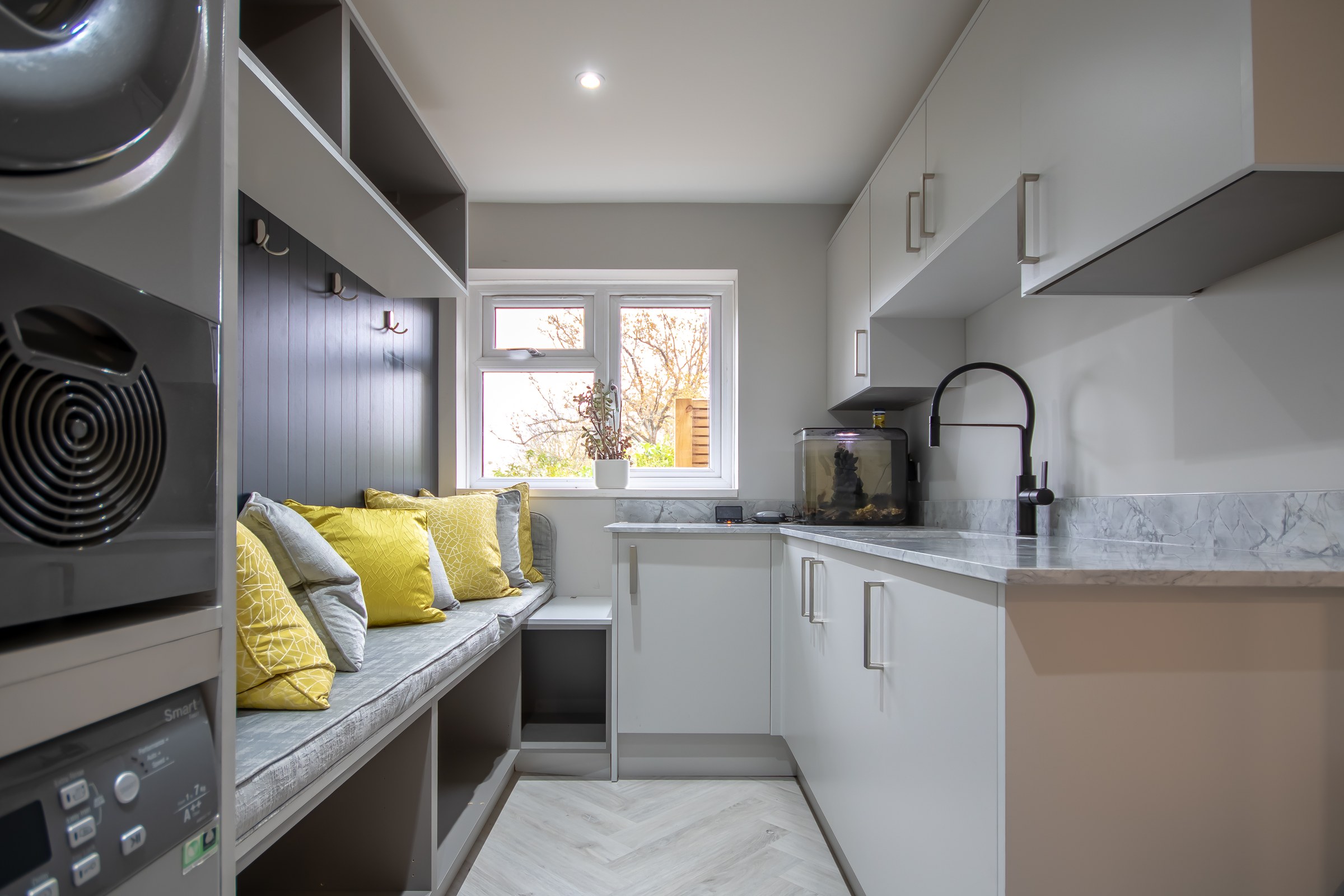 Surrey Peaks utility and boot room with built-in storage and laundry appliances