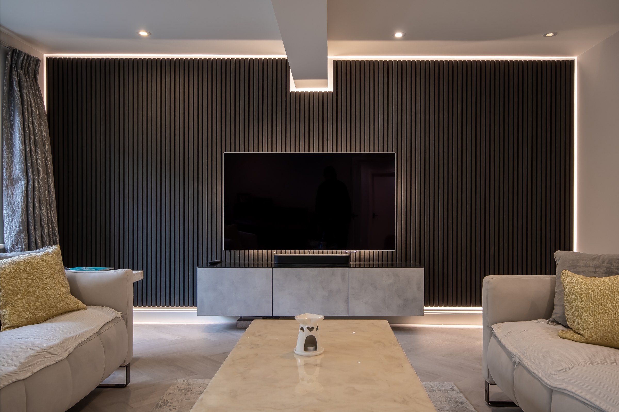 Surrey Peaks media room with bespoke slatted feature wall and television