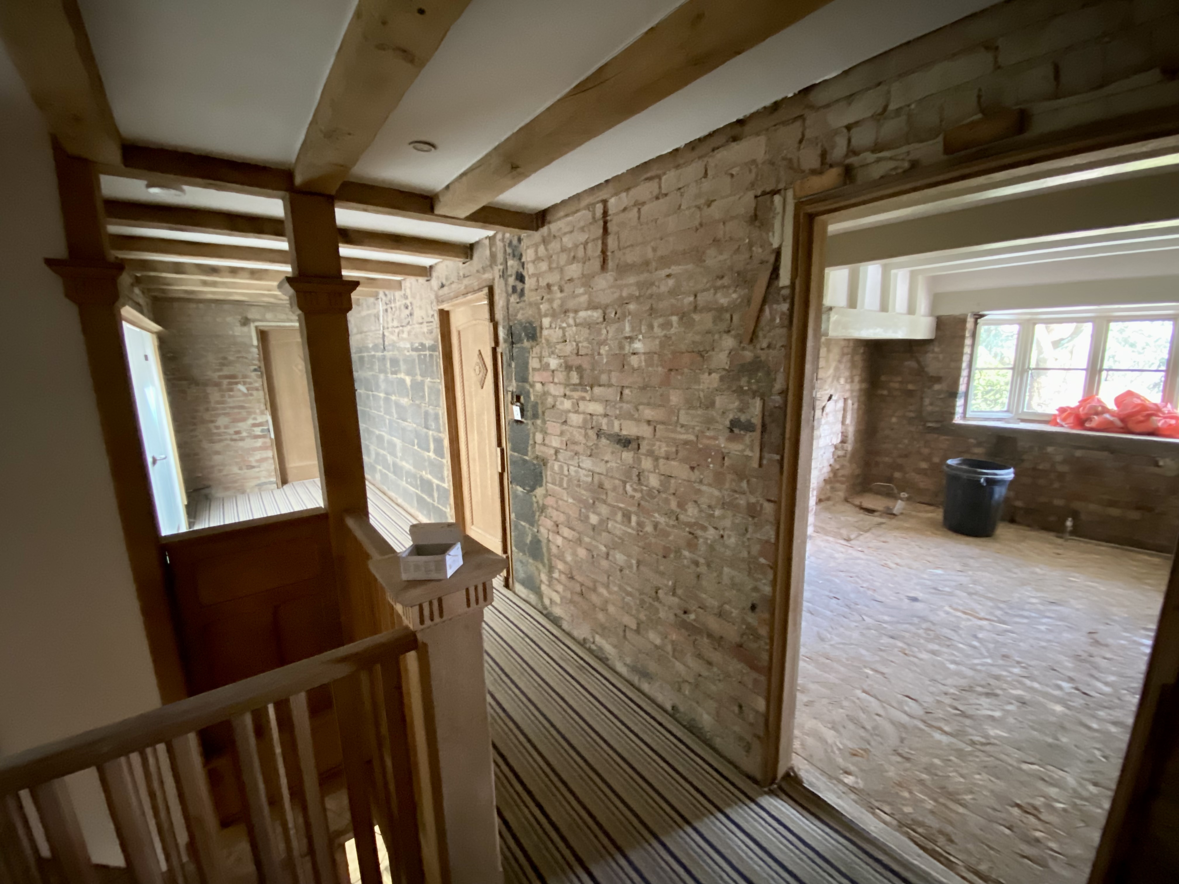 Hillside stripped back to bare brick around the original staircase and oak beams