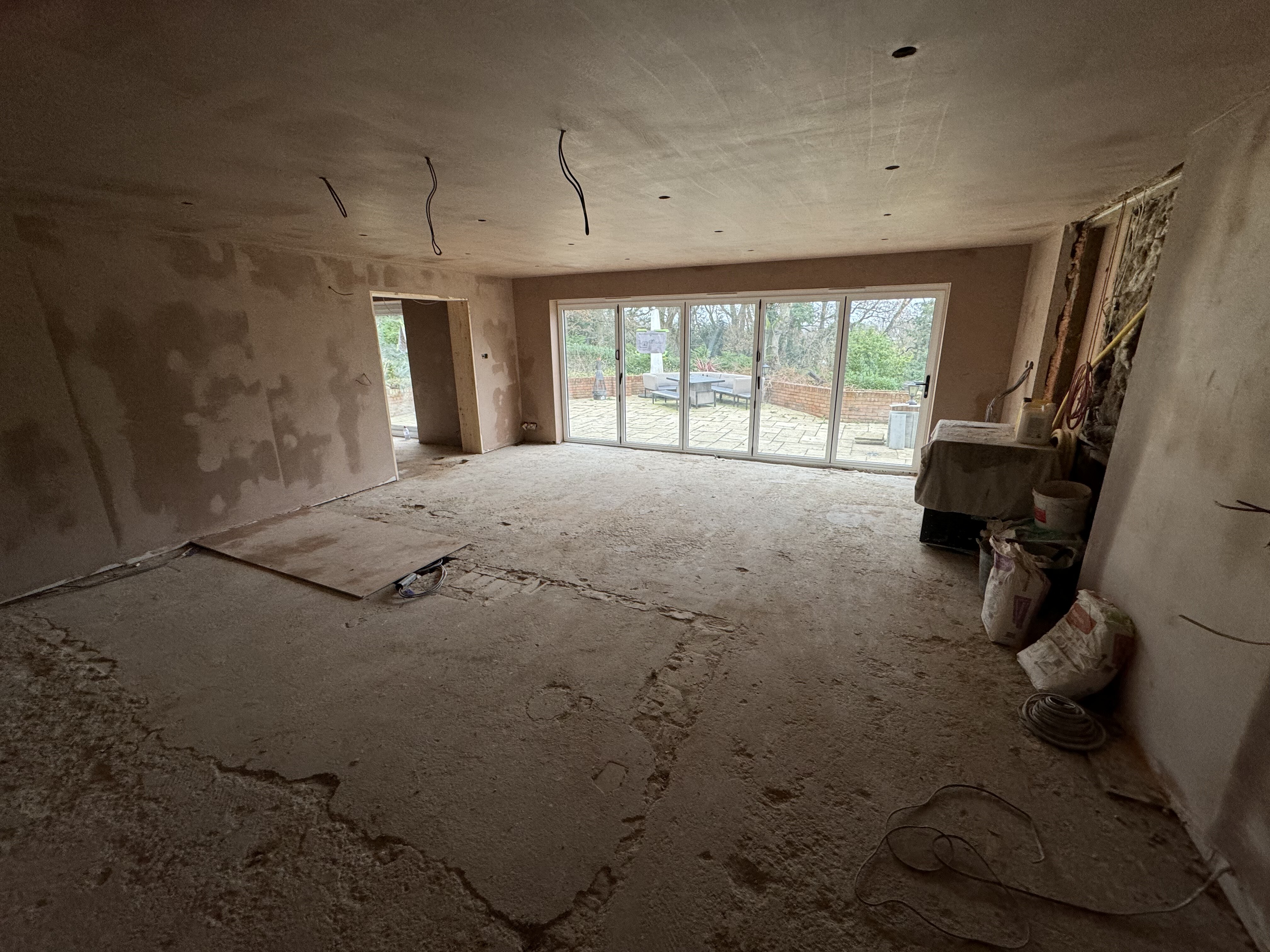 Ground floor after structural reconfiguration and plastering at Surrey Peaks