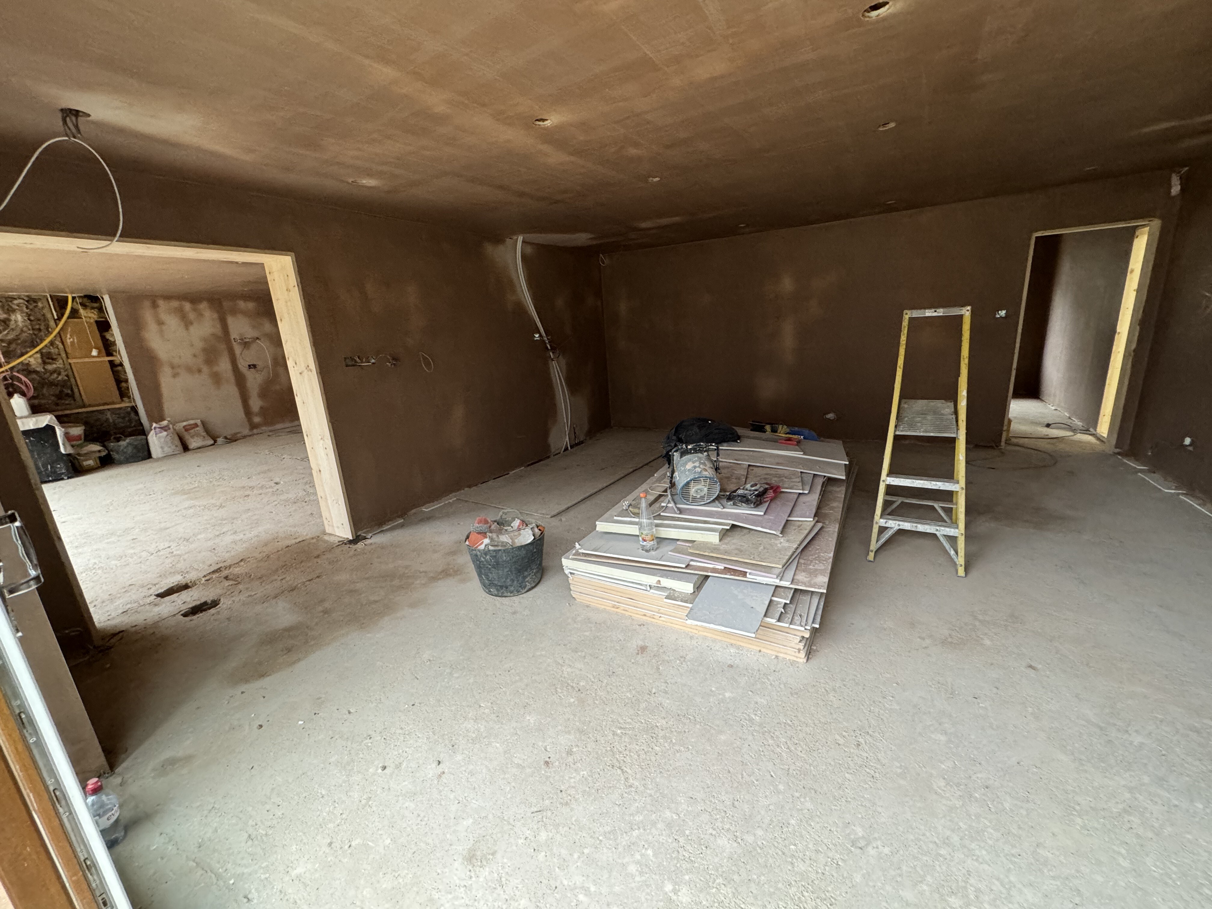 Ground-floor room during plastering and rebuild works at Surrey Peaks