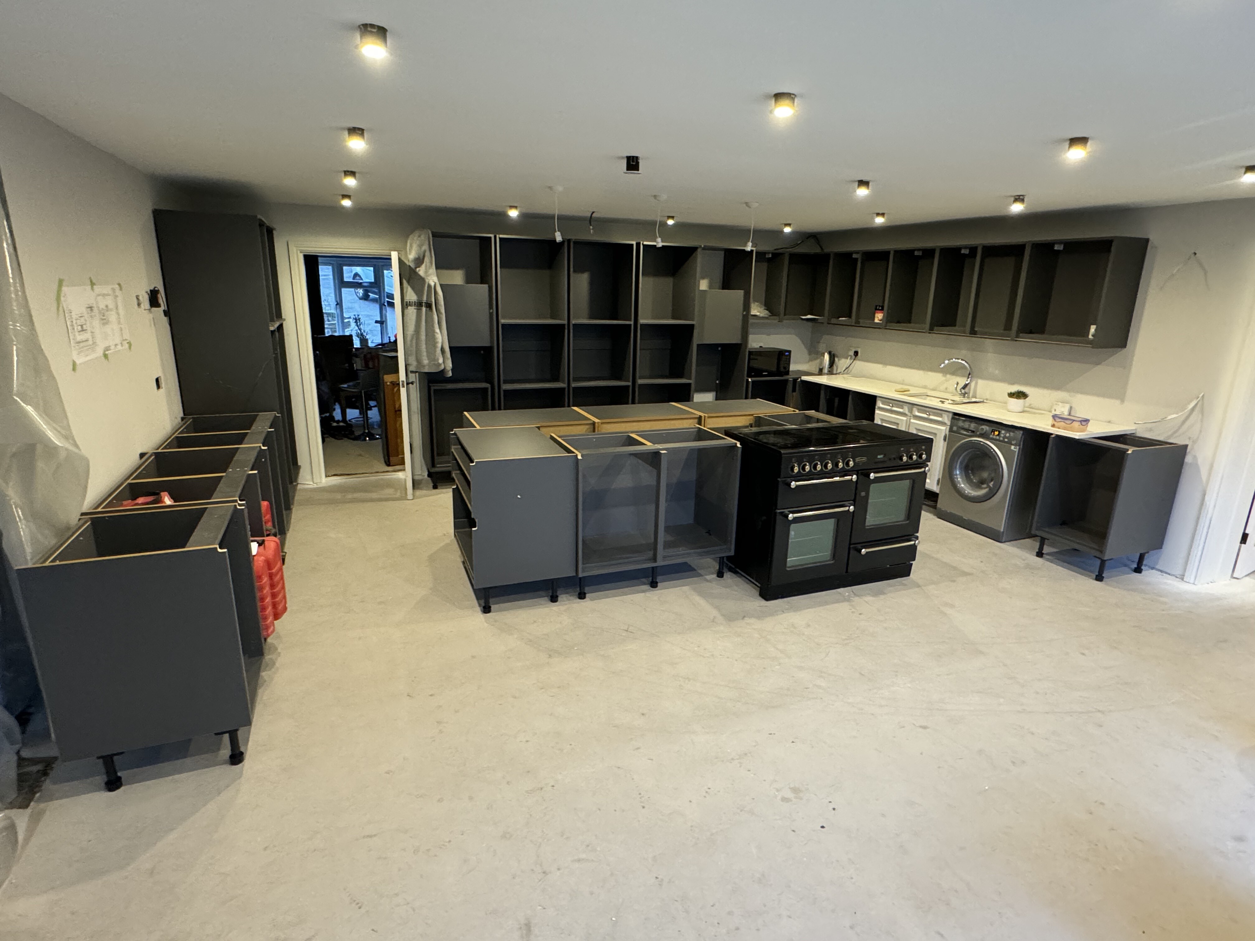 Kitchen cabinetry installation during the Surrey Peaks fit-out