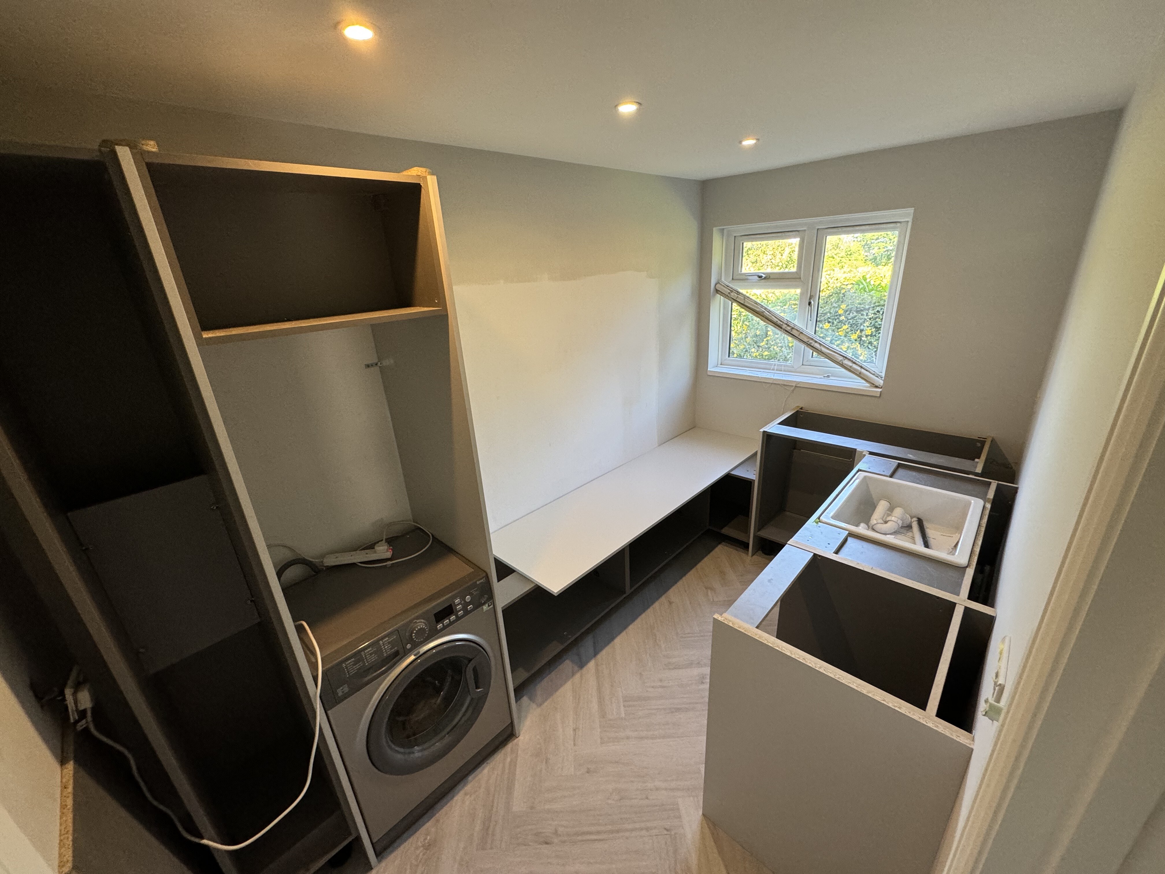 Utility room cabinetry installation during the Surrey Peaks fit-out