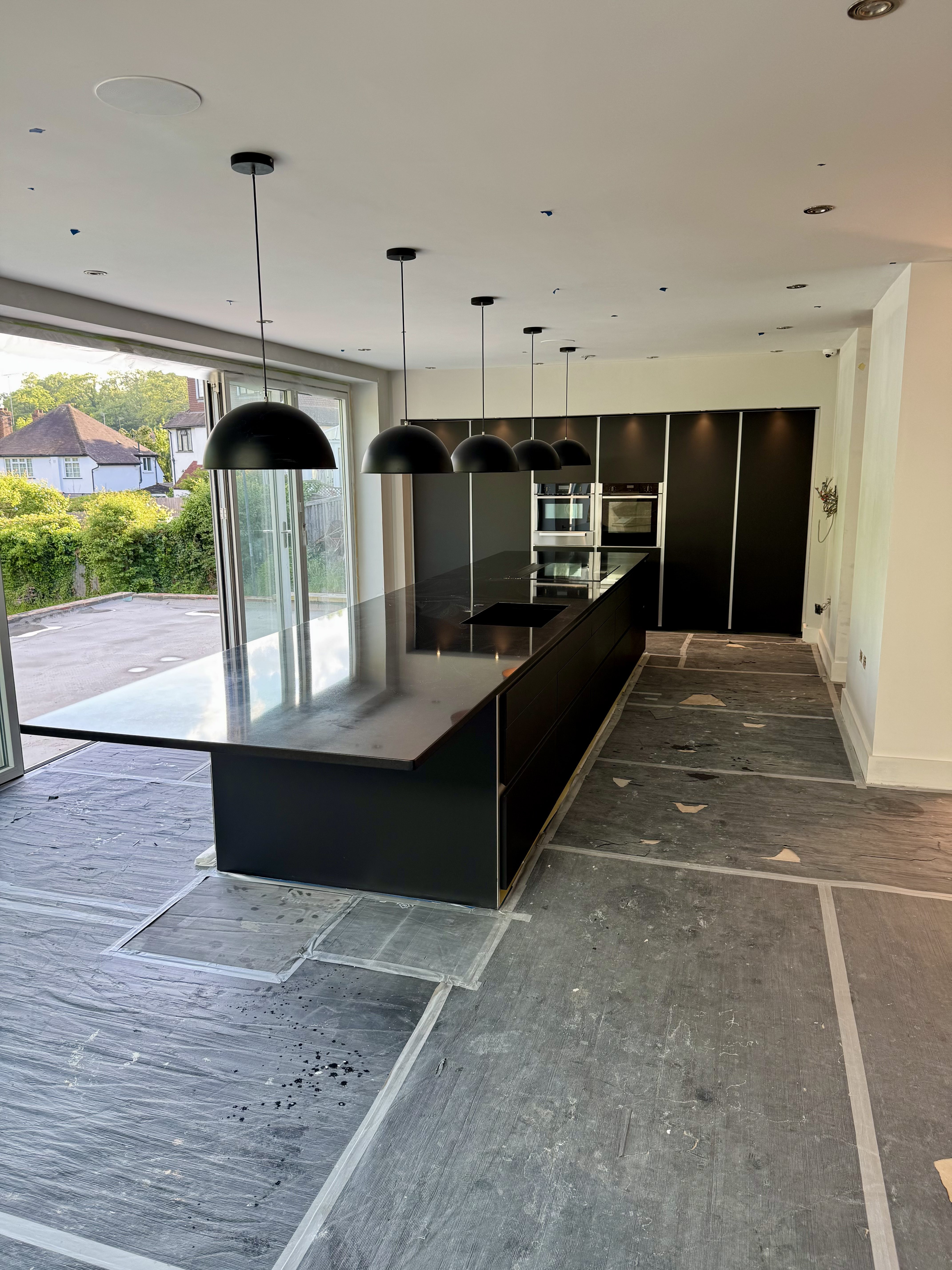 Dark cabinetry being installed in the Thornhill kitchen