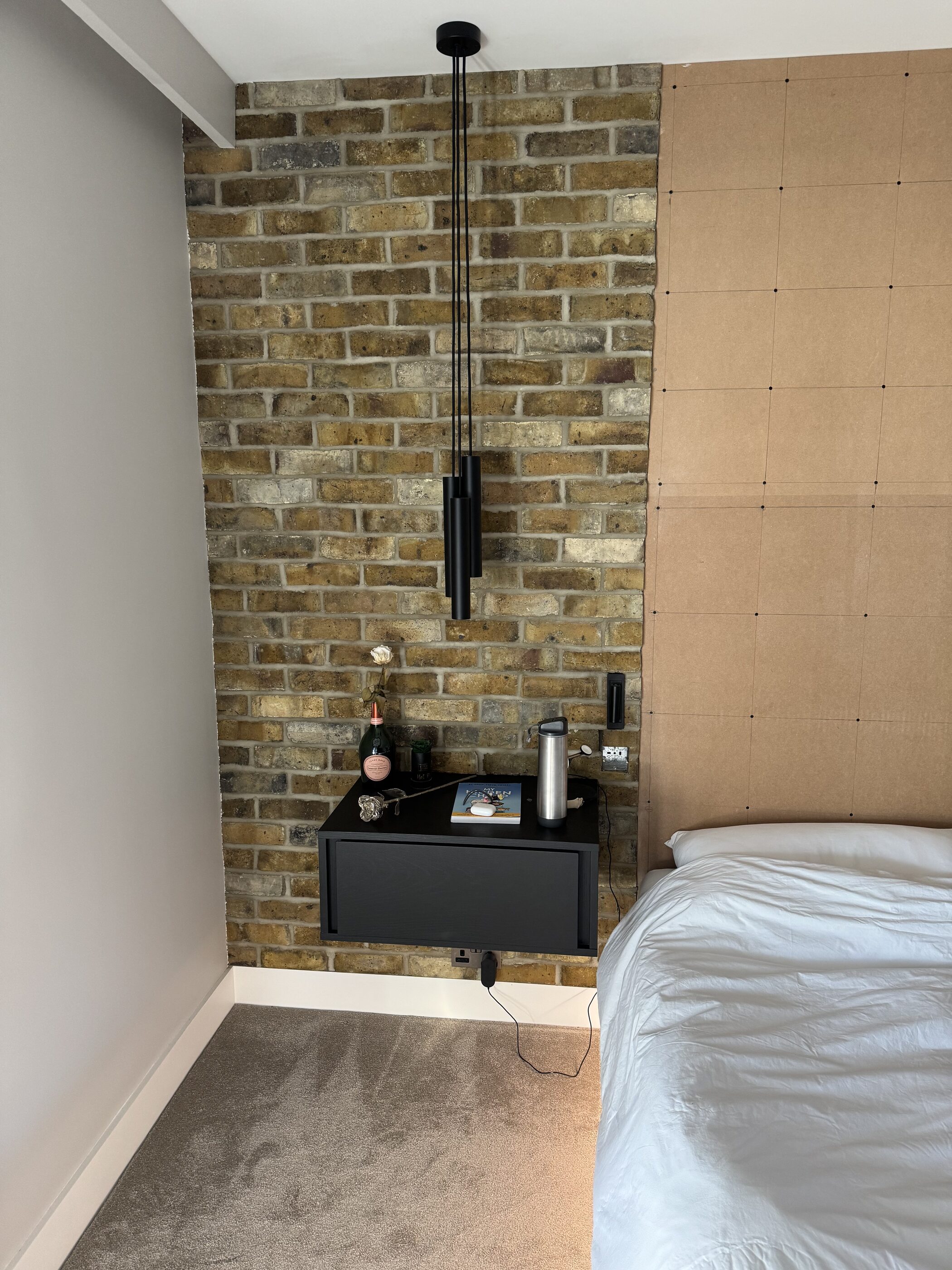 Thornhill bedroom with exposed brick feature wall and fitted joinery