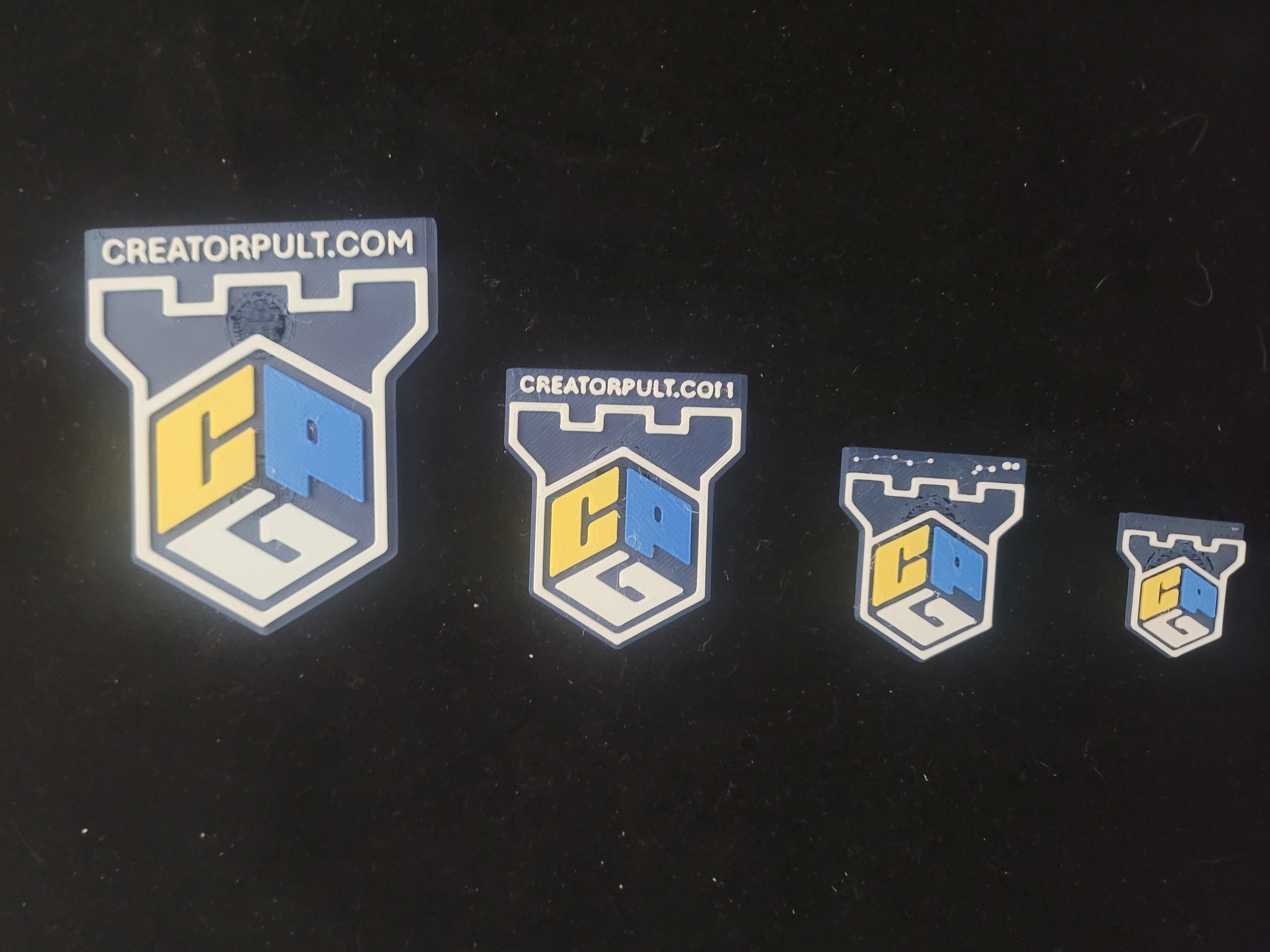 Multi-color 3D-printed logo badges in four sizes