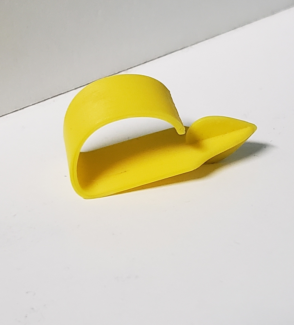 Yellow 3D-printed thumb pick with an angled tip
