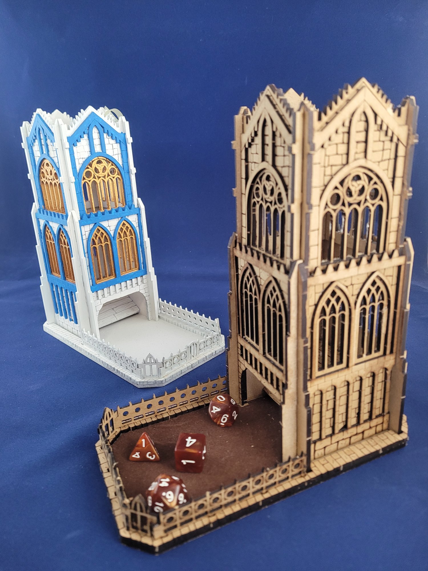 Two laser-cut wooden dice towers with Gothic window details