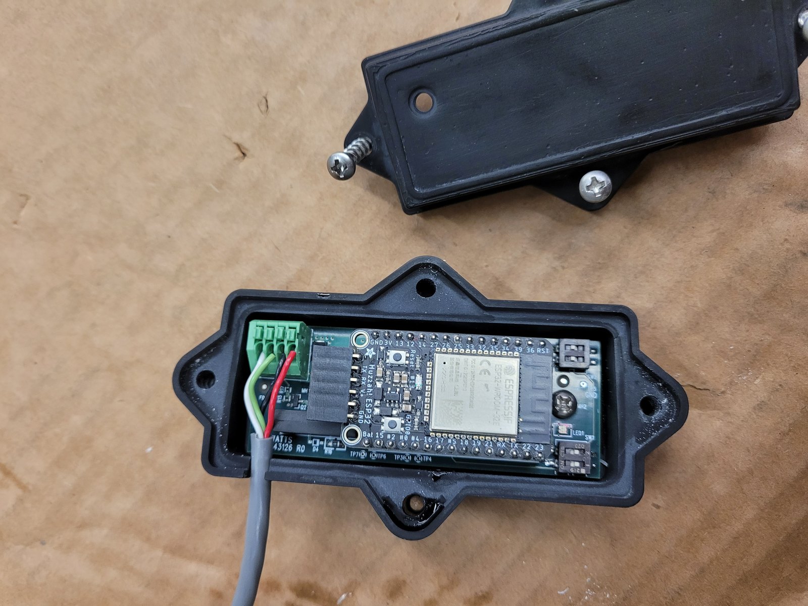 Custom 3D-printed enclosure housing a microcontroller board