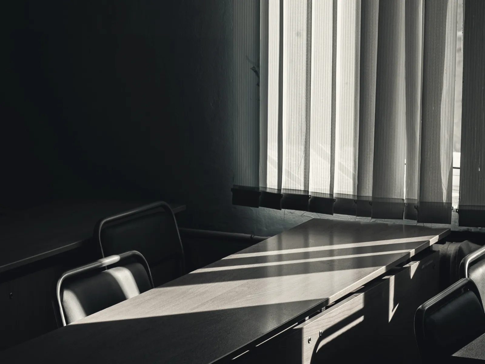 Low sunlight crossing an empty boardroom table