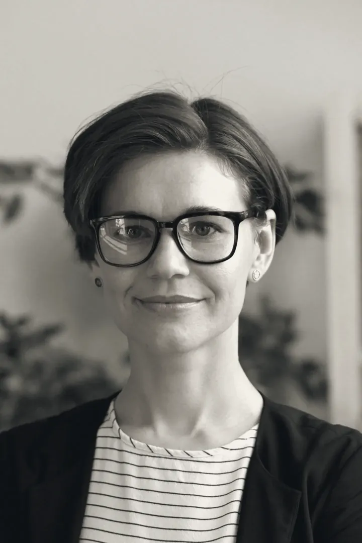 Nadia Fournier, principal for financial services, in glasses, with plants behind her