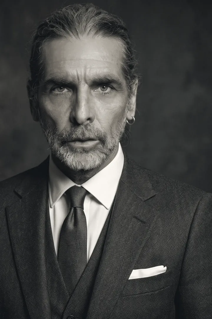 Tomas Reinholt, partner for health systems, in a dark suit against a dark backdrop