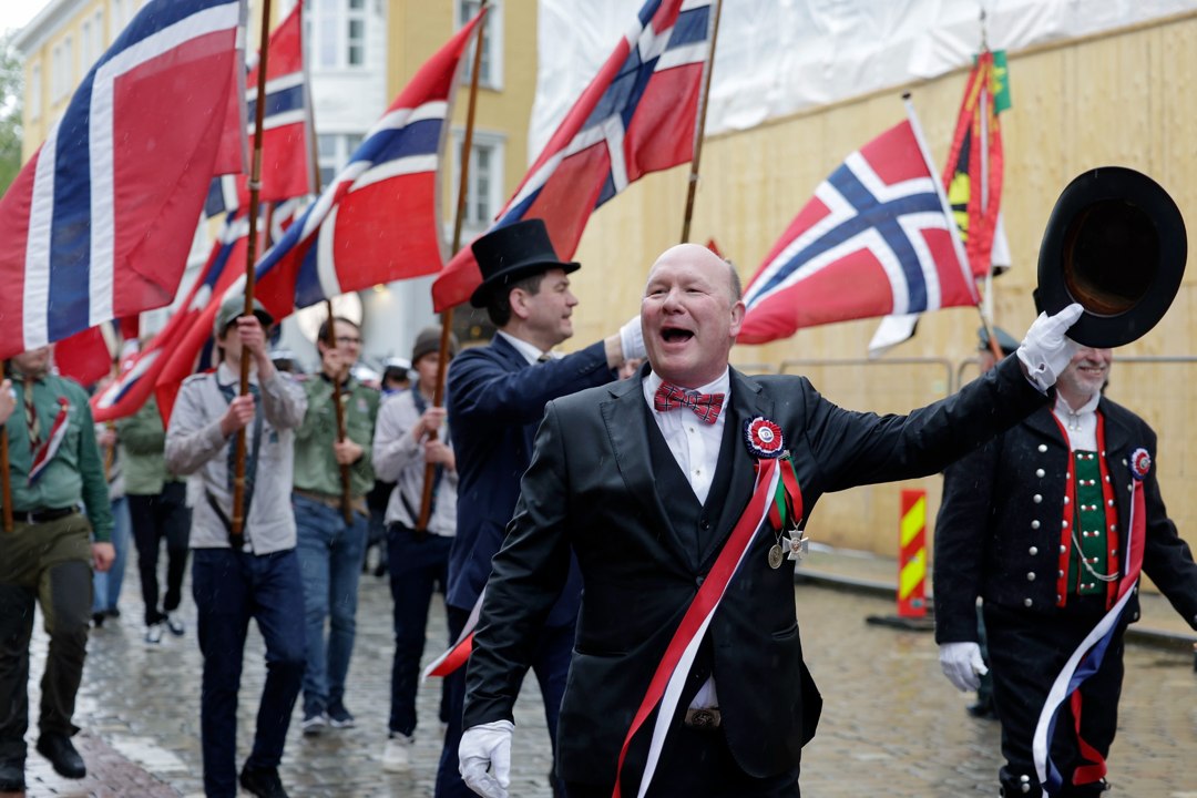 Deltakere med flosshatt og norske flagg i hovedprosesjonen – _SKR5484