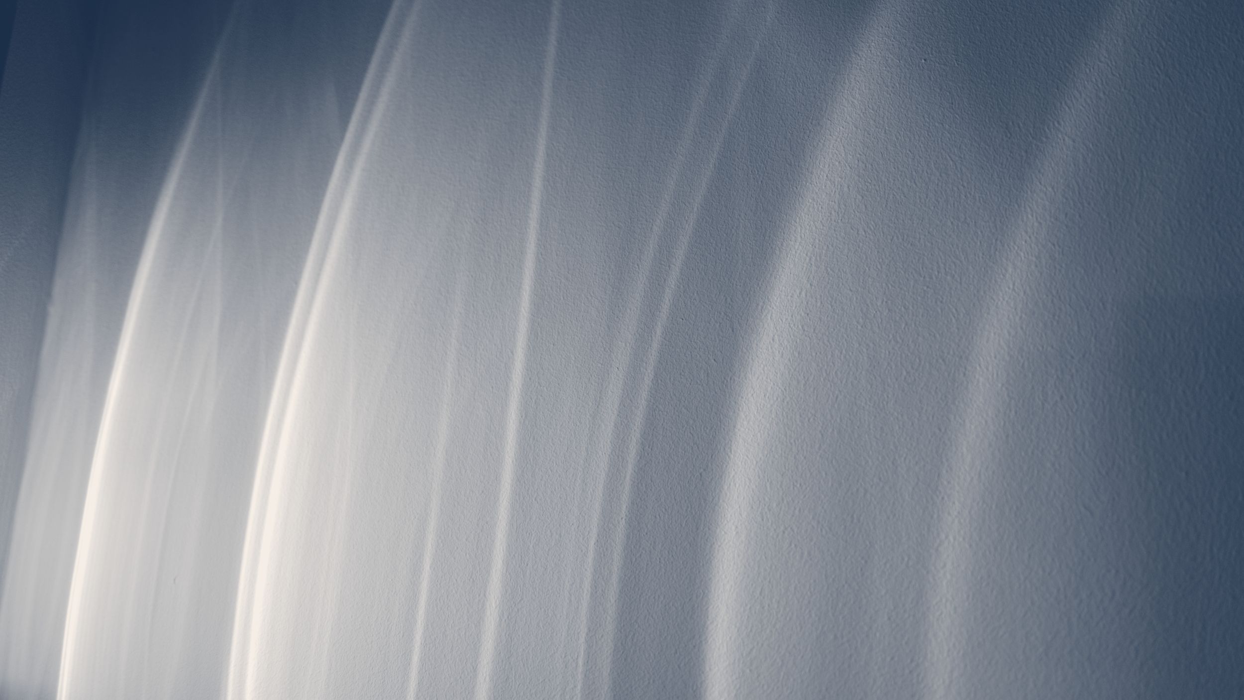 Light streaks across a wall, navy and cream