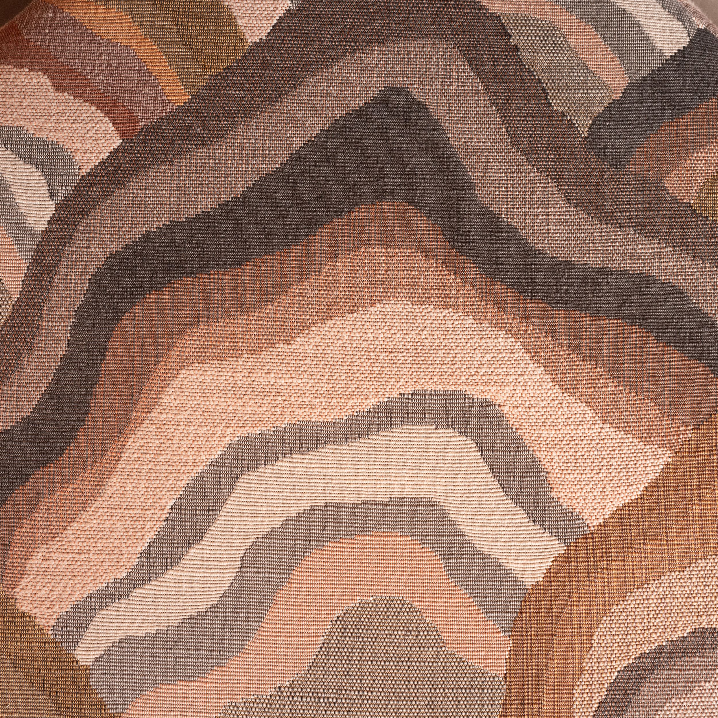 Woven jacquard fabric with contour pattern in peach, brown and grey