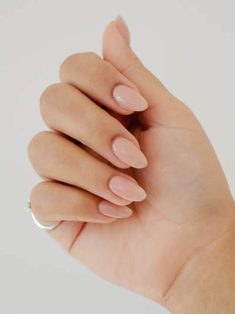 Photo of female hands with soft pink nails