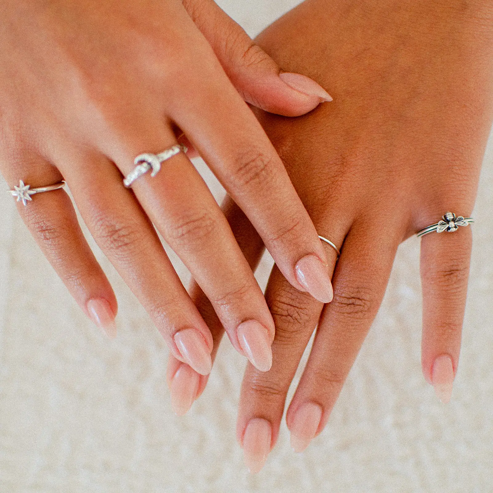Photo of hands in water with flowers floating on top