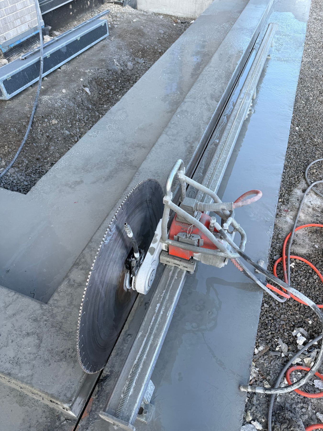 Track saw cutting a concrete slab