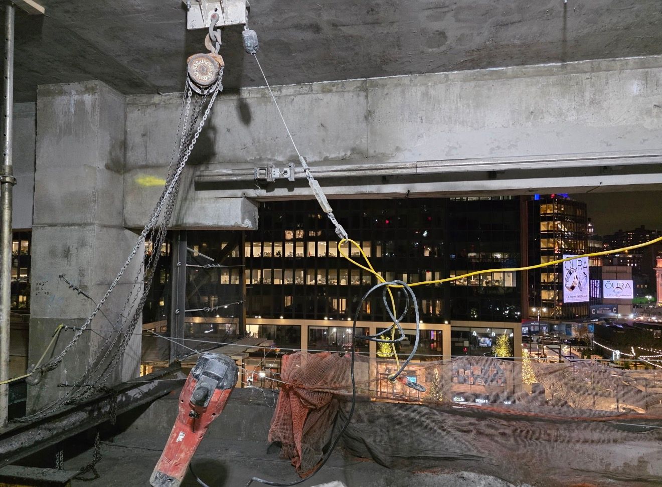 Chain hoist rigging for a cut concrete section at night