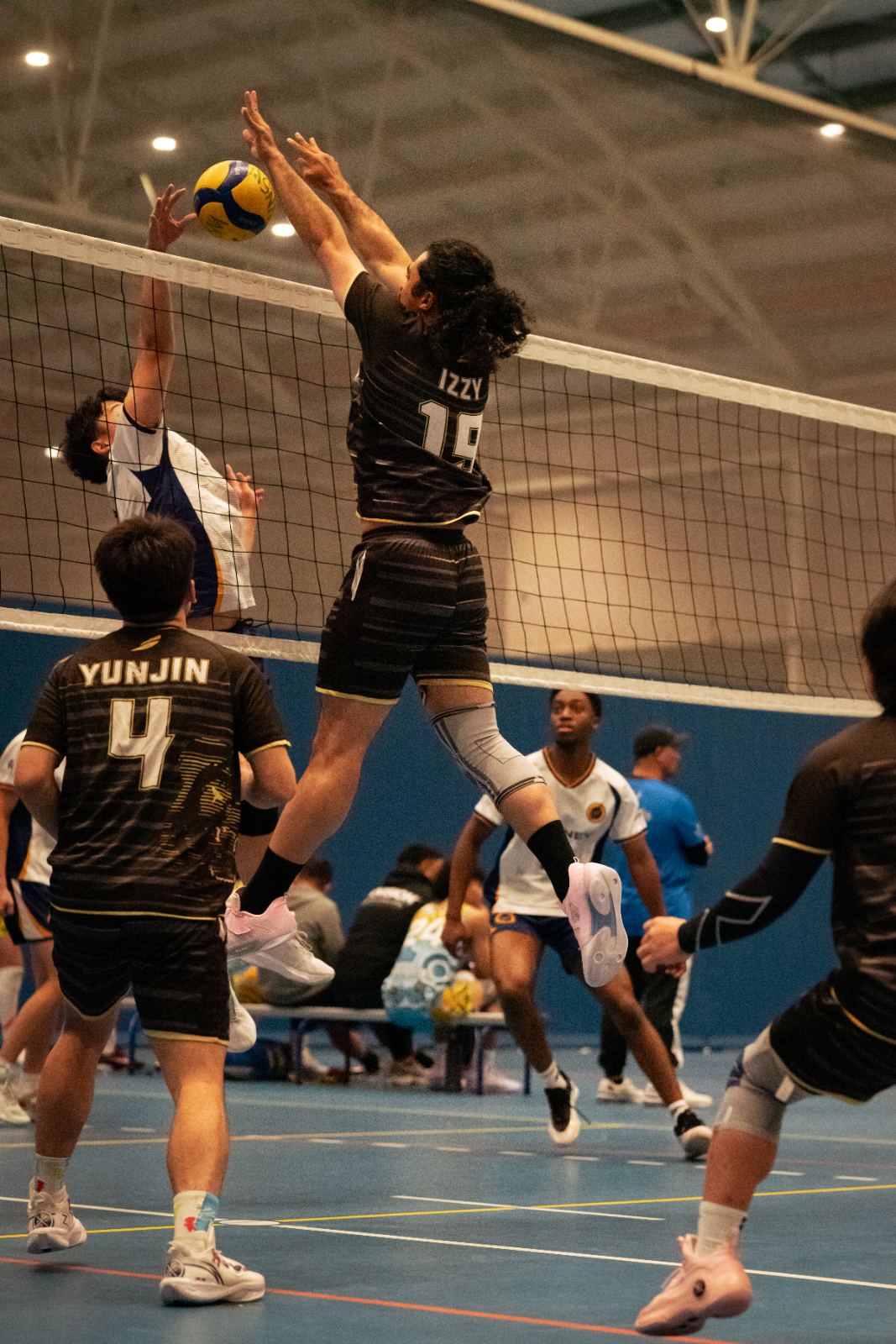 A Bossley Bears player blocking at the net